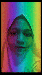 a girl wearing a white hijab with a rainbow colored background