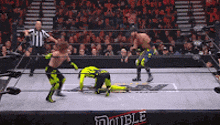 two wrestlers are in a wrestling ring with the word double on the side