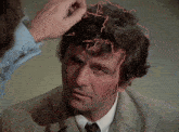 a man 's head is being examined by a person with a red line coming out of it