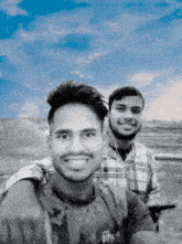 two young men are posing for a picture with one wearing a shirt that says ' a ' on the front