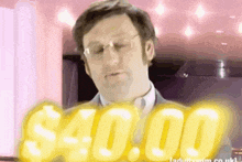 a man wearing glasses is standing in front of a sign that says $40.00