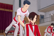 a man in a red and white uniform is giving another man a shoulder massage