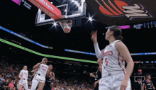 a basketball player with the number 5 on her jersey shoots the ball