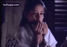a woman in a white shirt and tie is looking at herself in a mirror .