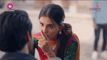 a woman covering her mouth with her finger and a jio cinema logo in the background