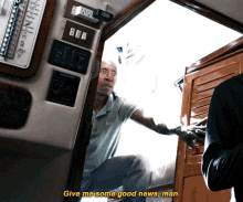 a man kneeling down in a room with the words give me some good news man