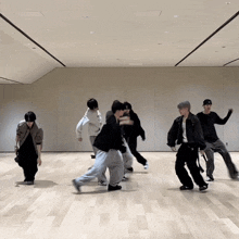 a group of young men are dancing in a room