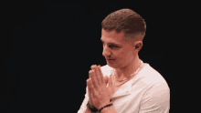 a man with his hands folded in prayer