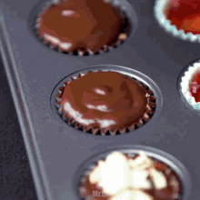 a tray of cupcakes with the word mr. on the bottom right