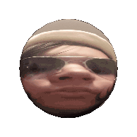 a woman wearing a beret and sunglasses looks at the camera