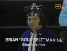 a man wearing a crown and a purple robe is called brian " gold belt " maxine