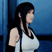 a woman with long black hair is wearing a white tank top and black gloves