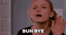 a woman is smiling and says " buh bye " in white letters