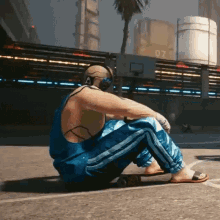 a man wearing headphones sits on a skateboard in front of a basketball hoop with the number 07 on it