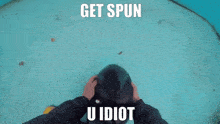 a person is petting a seal that says get spun u idiot on the bottom
