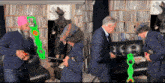 a man in a blue suit and a woman in a plaid hat are playing with a toy gun