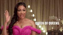 a woman in a pink dress with queen of queens written on the bottom