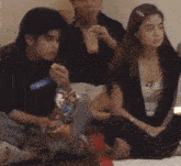 a group of people are sitting on the floor with one wearing a name tag that says " will "