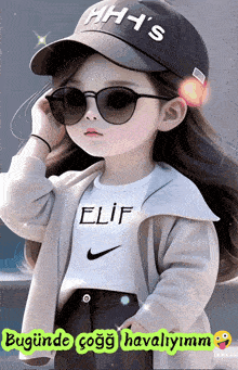 a little girl wearing sunglasses and a hat with the name elif on her shirt