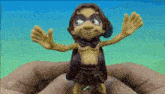 a person is holding a toy in their hands that looks like a monkey