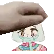 a hand is holding a cartoon character 's head with a straw in her mouth .