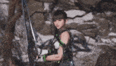a woman in a video game is holding a sword in her hand .