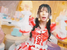 a girl wearing a red and white dress with a spider web on it