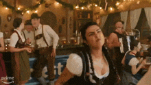 a woman is dancing in a room with a sign that says prime in the background
