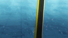 a black and yellow pole is floating in the ocean