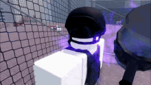 a purple glowing object is behind a fence with a person in a black helmet