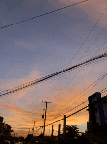 a sunset with a lot of power lines going through it