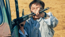 Holding The Gun Jackie Chan GIF - Holding The Gun Jackie Chan Tang Huating GIFs