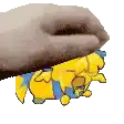 a hand is holding a yellow cartoon character .