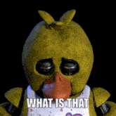 chica the chicken from five nights at freddy 's is wearing a bib that says " what is that " on it