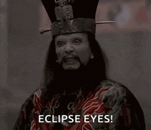 a man with eclipse eyes and a hat on