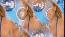 a woman in a bikini is dancing in the water in a video .