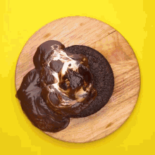 a chocolate cake with s'mores on top on a wooden cutting board