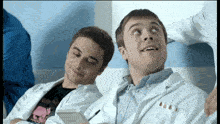 a man in a white lab coat has a sticker on his jacket that says ' 00 '