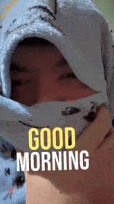 a picture of a person wrapped in a towel with the words " good morning " on it