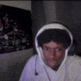 a man wearing headphones is looking at the camera .