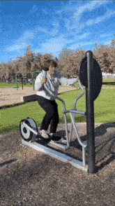 a person is riding an elliptical machine in a park