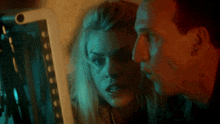 a man and woman are looking at a computer screen
