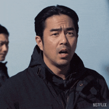 a man in a black jacket with the word netflix on the bottom right