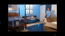 a man in a blue shirt is standing next to a box in a room