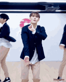 a man in a suit is dancing in front of a sign that says homespired