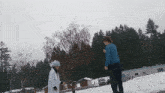 two people are standing in the snow and one is wearing a wig