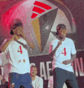 two men wearing shirts with the number 4 on them