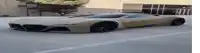 a brown sports car is parked on the side of the road .
