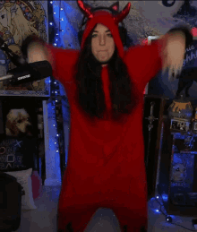 a woman in a red devil costume with a shure microphone in the background