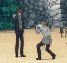 a man in a suit taking a picture of another man